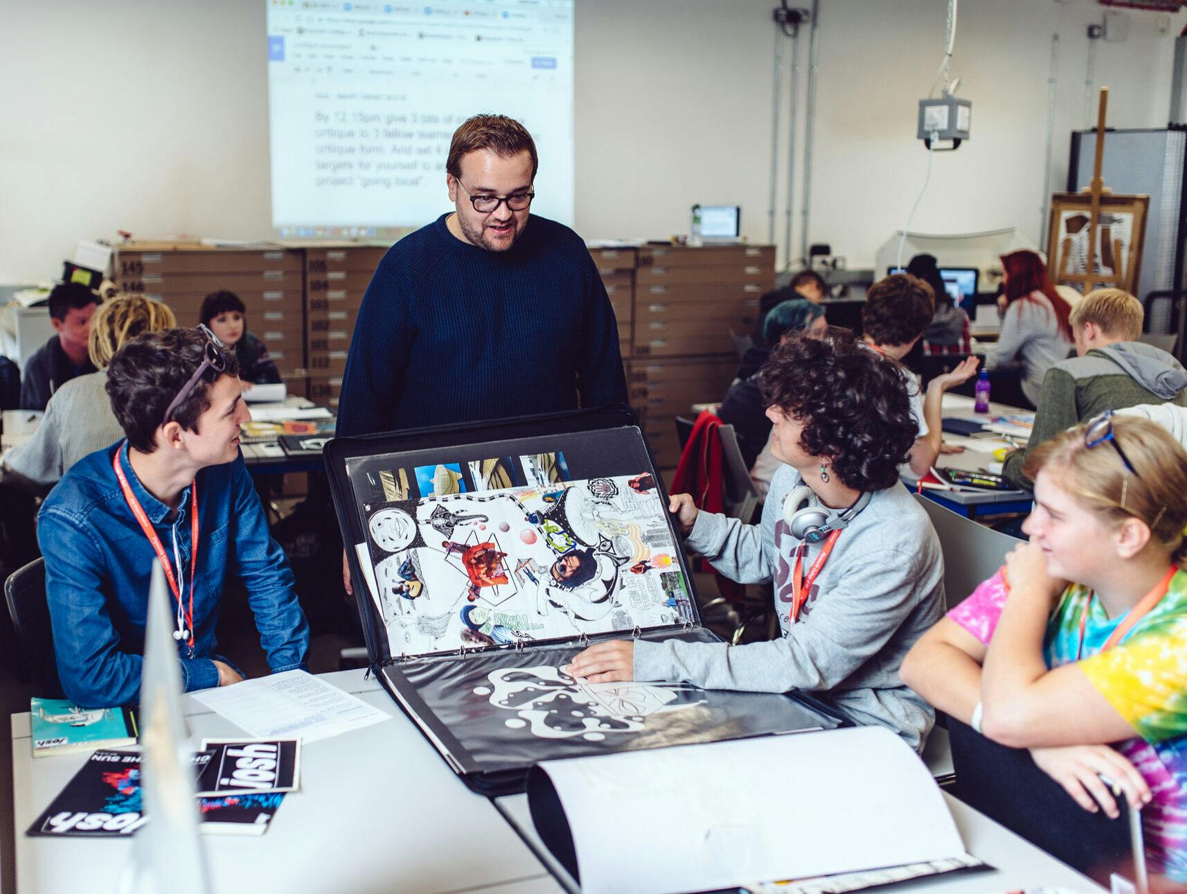 Steven Forsyth, Head of Pre-Degree, chats to students in the Graphics studio at our Palace Court campus