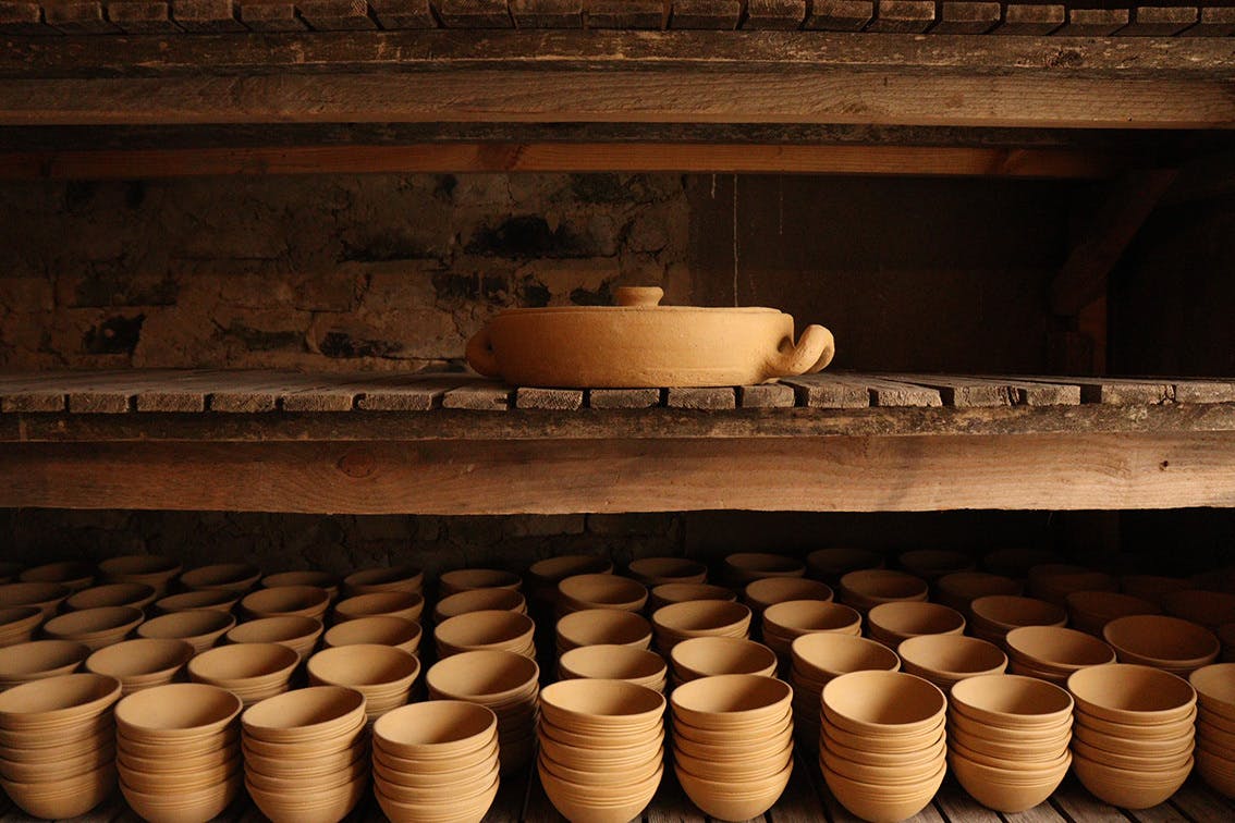 Bowls and a lidded dish await glazing at Roland Tsartsidzes pottery workshop in Jalaurta Sachkere Imereti Region West Georgia Photo Credit Makuna Gotsadze