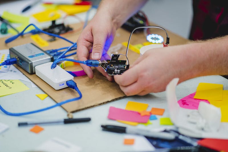 A student plugs colourful blue cables into an electrical circuit AYCH Day 2 2018