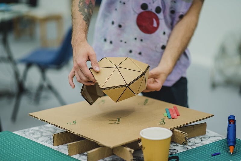 Hands holding a cardboard structure AYCH Day 2 2018